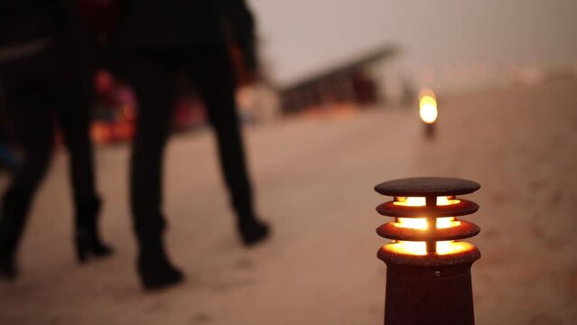 Lighted lantern on background of people walking