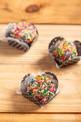 Brigadeiros, beautiful colorful sweets on rustic wood, selective focus.