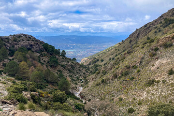 Panoramic view from hiking trail to Maroma peak in thunderstorm day, Sierra Tejeda, Spain 
