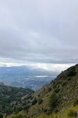 Fototapeta premium Panoramic view from hiking trail to Maroma peak in thunderstorm day, Sierra Tejeda, Spain 
