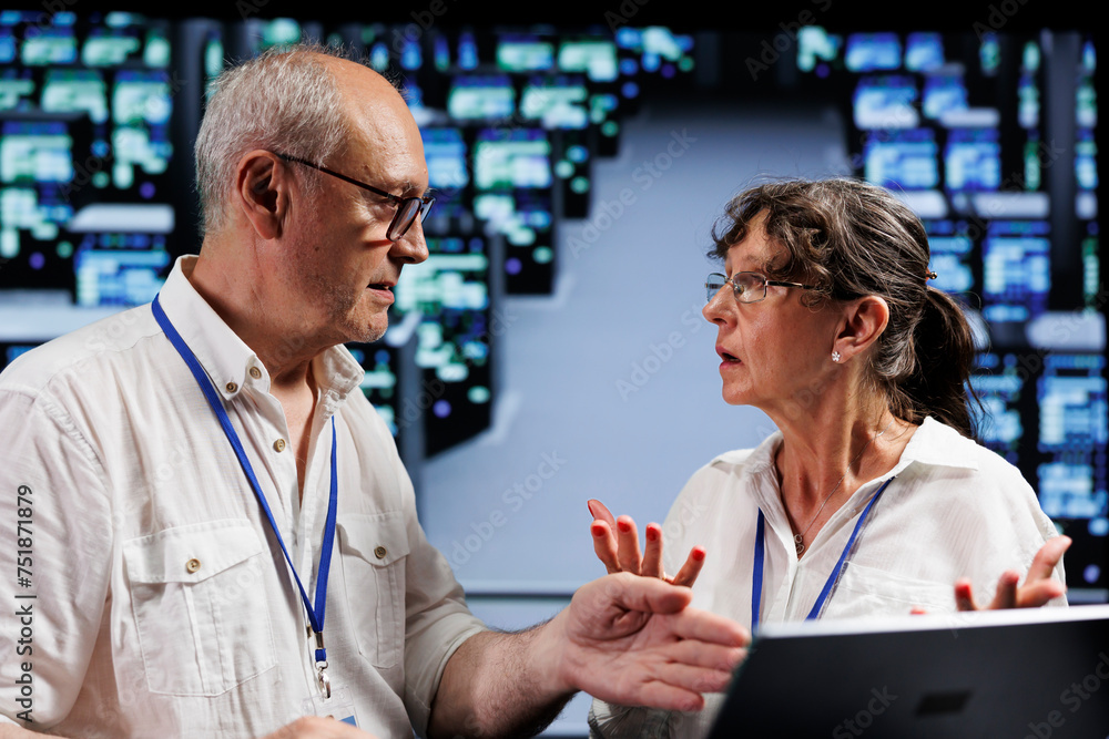 Poster octogenarian employees working to maintain uptime in high tech workspace. efficient workers brainsto