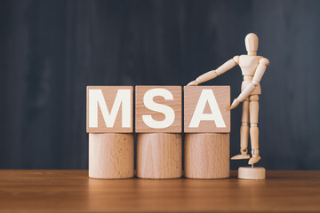 There is wood cube with the word MSA. It is an abbreviation for Master Service Agreement as eye-catching image.