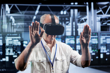 Senescent technical support consultant immersed in virtual reality at data center, doing equipment...