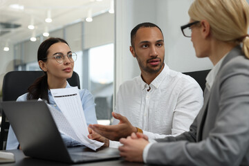 Lawyers working together at table in office