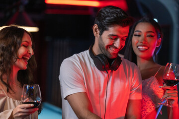 DJ musician man playing and mixing a song with a turntable and headphone. Dance party. excited dj...