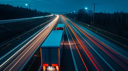 Poster Trucks on highway in night time. Motion blur, light trails. Transportation, logistic. Timelapse, hyperlapse of transportation. Abstract soft glowing lines © Enrique