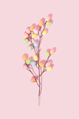 Pattern composition made of pastel color eggs on branch. Flat lay. Top view. Minimal idea of Easter.