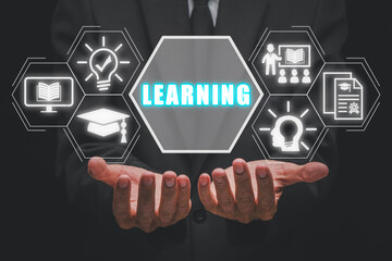 Learning concept, Businessman hands holding learning icon on virtual screen.