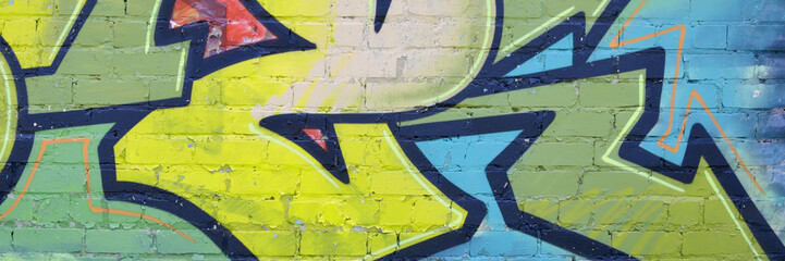 Colorful background of graffiti painting artwork with bright aerosol outlines on wall. Old school...