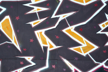Colorful background of graffiti painting artwork with bright aerosol outlines on wall. Old school...