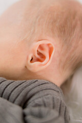 Close-up of a newborn baby's head of soft hair and ears. 