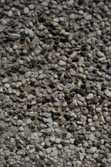 wall of round stones of different colors and sizes. stone texture
