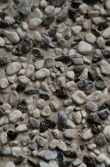 wall of round stones of different colors and sizes. stone texture