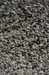 wall of round stones of different colors and sizes. stone texture