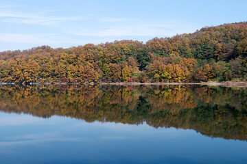 Reflection of the autumn mountain on the lake