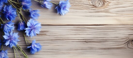 A collection of blue flowers arranged on top of a wooden table, showcasing the vibrant colors and textures of the blossoms against the rustic backdrop.