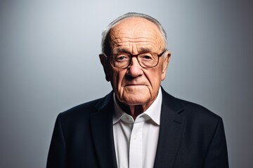 Portrait of a senior man with glasses. Isolated on grey background.