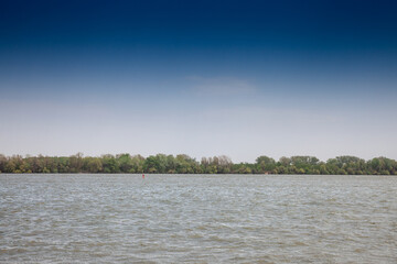 Panorama of the danube waters in Belgrade, Serbia, with a blue sky. Reka dunav, or danube river, is a major river of Europe and a huge navigation axis.