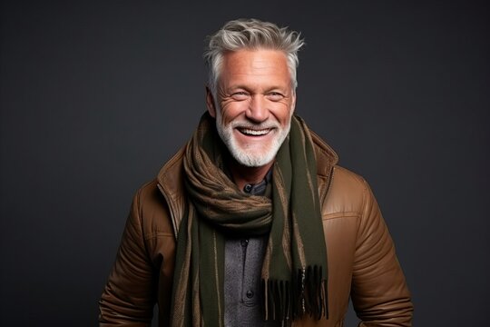 Portrait of a smiling senior man wearing a warm jacket and scarf.