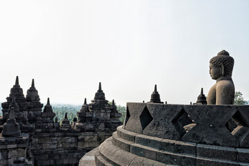 Buddha statue on the top platform of Borobudur, the largest Buddhist temple in the world