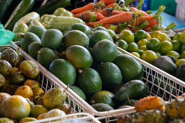 Fresh ripe green avocados, tropical fruits and vegetables on farmers market on Fuerteventura, Canary islands, Spain