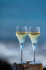 Pouring a glass of champagne on vacation, south of Fuerteventura, Canary islands, blue ocean, mountains