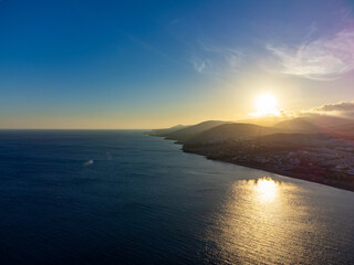 Aeriav view on sandy dunes, beach and Costa Calma, Fuerteventura, Canary islands, Spain in winter on sunset