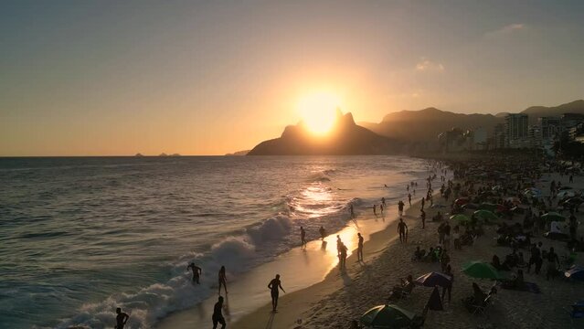 Aerial View of Crowded Ipanema Beach on Sunset and Waves in the Ocean in Rio de Janeiro, Brazil