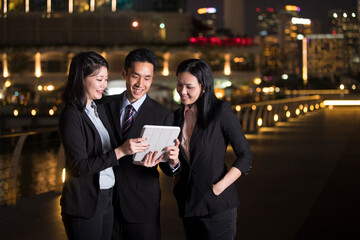 Chinese Business team in city at night.