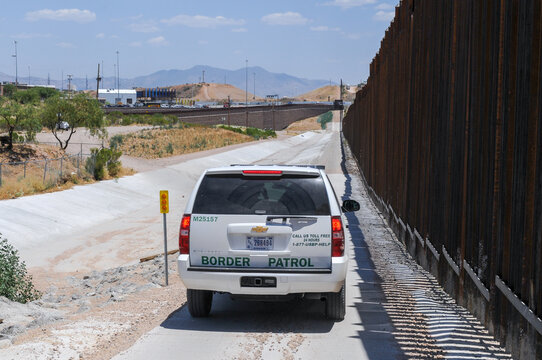 In Nogales, Arizona, a vehicle from the U.S. Customs and Border Protection agency travels alongside the border fence with Mexico