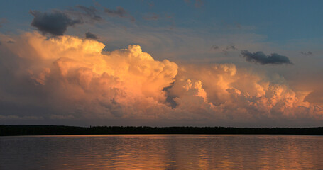 Golden Thunderstorm Clouds on Horizon Over Northern Minnesota Lake at Sunset