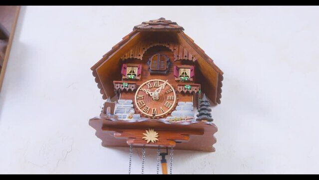 An intricately decorated cuckoo clock displaying traditional craftsmanship and ornate details, symbolizing timeless artistic skill.