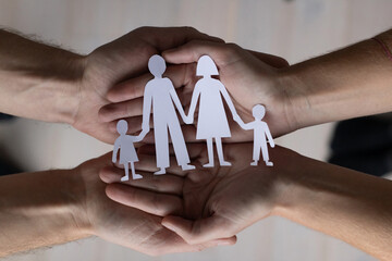family care and insurance concept, childcare, social help, hands holding paper family - 751947854