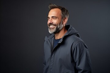 Portrait of a smiling middle-aged man in a jacket.