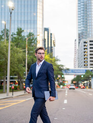 Business man walking in the street in downtown of modern city. Business success of business man outdoor. Handsome successful businessman in elegant suit outdoors.