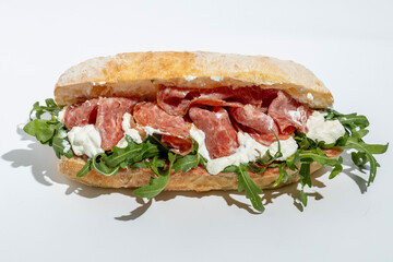sandwich with salami and cheese on white background