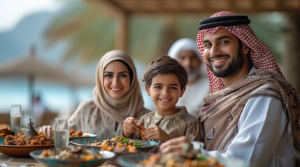 islamic family eating together at outdoor restaurant on arabian beach