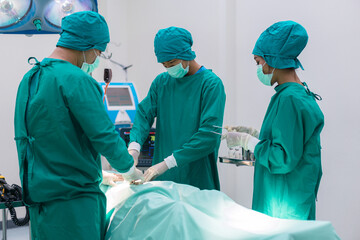 Medical team doing critical operation. Group of surgeons in operating room with surgery equipment at hospital.