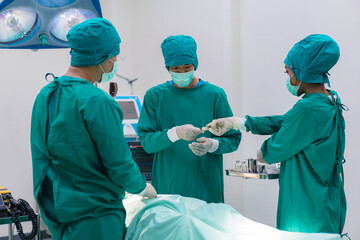 Medical team doing critical operation. Group of surgeons in operating room with surgery equipment at hospital.