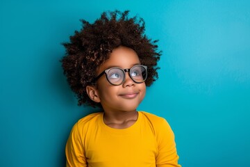 Curious child with glasses looking up