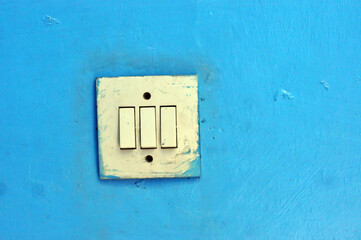 vintage electric switch on a blue wall
