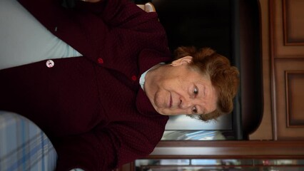 Vertical video of older caucasian woman with brunette hair talking indoors - Powered by Adobe