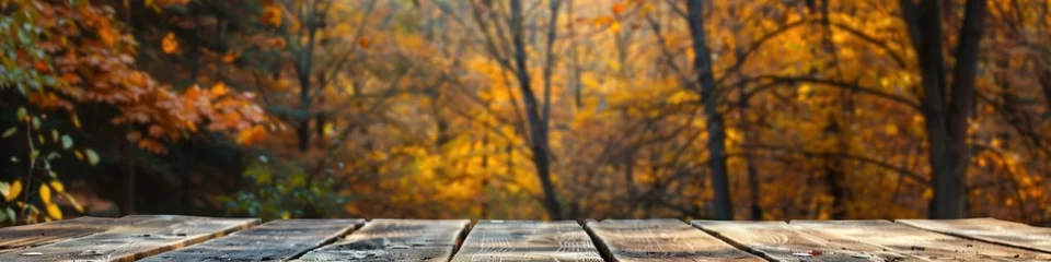 Fotobehang Empty rustic wooden table for displaying products with blurred background of autumn forest. © somchai20162516