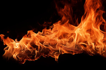 Fototapeta premium Fire and flames captured in a closeup shot against a black background, creating a striking contrast of heat and darkness, resembling a piece of art in motion