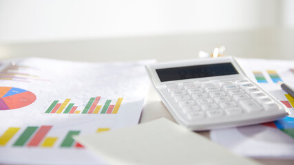 Desk with calculators for calculating, managing and
analyzing economic profits and losses.