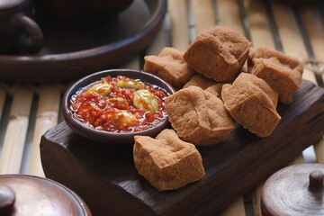Savory and delicious fried tofu served with garlic chili sauce and petai