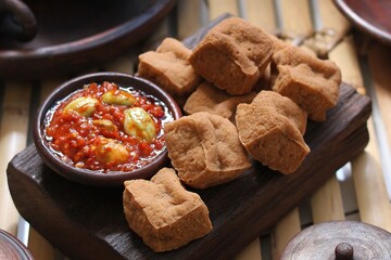 Savory and delicious fried tofu served with garlic chili sauce and petai