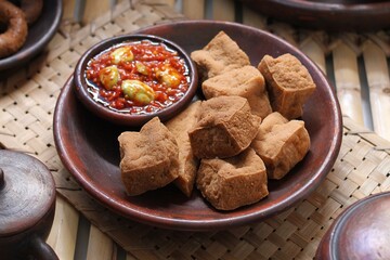 Savory and delicious fried tofu served with garlic chili sauce and petai