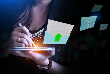 Woman is sending an email in a blue envelope with the Send symbol on a black background. Email inbox online communication sending concept