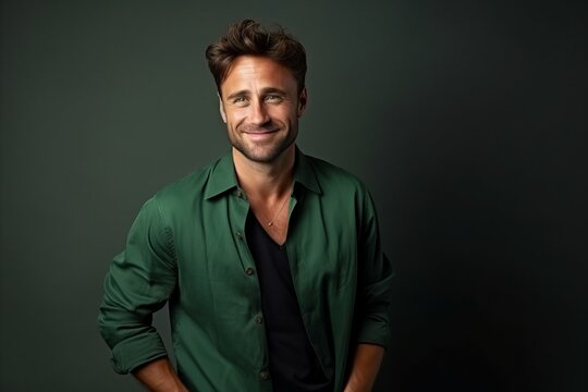Portrait of a handsome man in a green shirt smiling at the camera